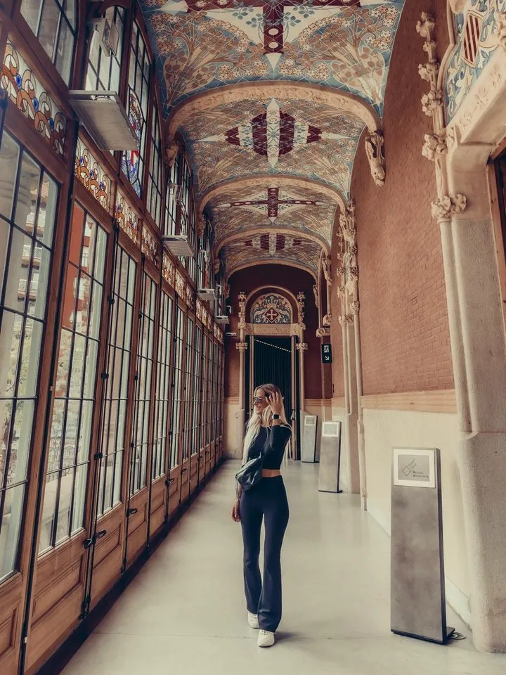 Valeria standing in a tiled, vaulted corridor at the Sant Pau Modernist Site